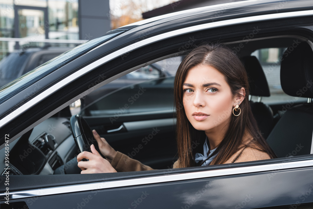  woman looking out from side window while driving car