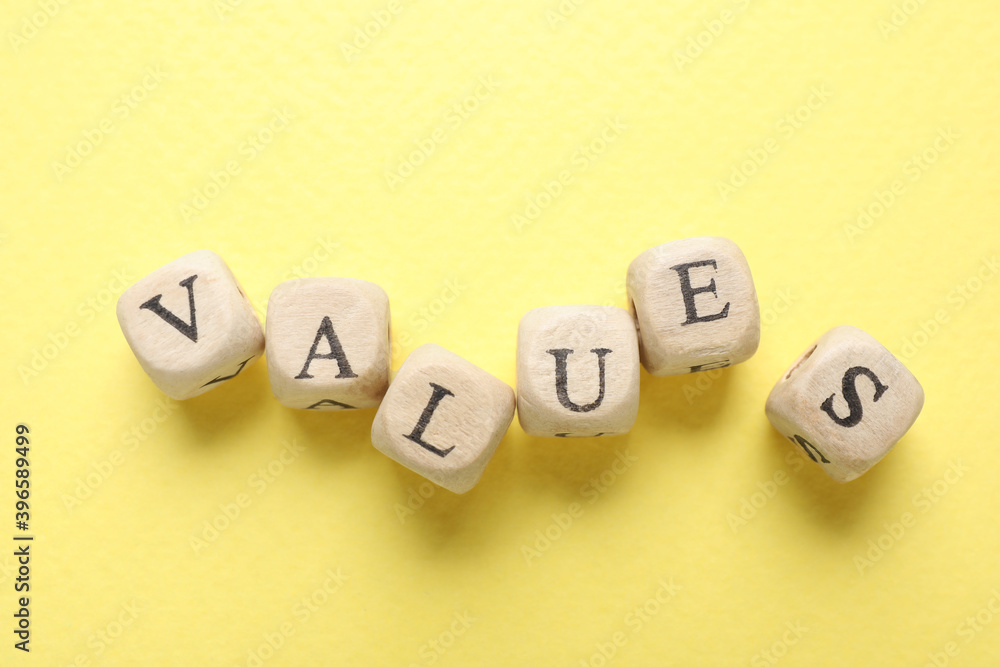 Beads with word VALUES on yellow background, flat lay Beads with word VALUES on yellow background, flat lay