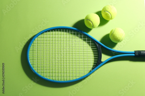 Tennis racket and balls on green background, flat lay. Sports equipment © New Africa