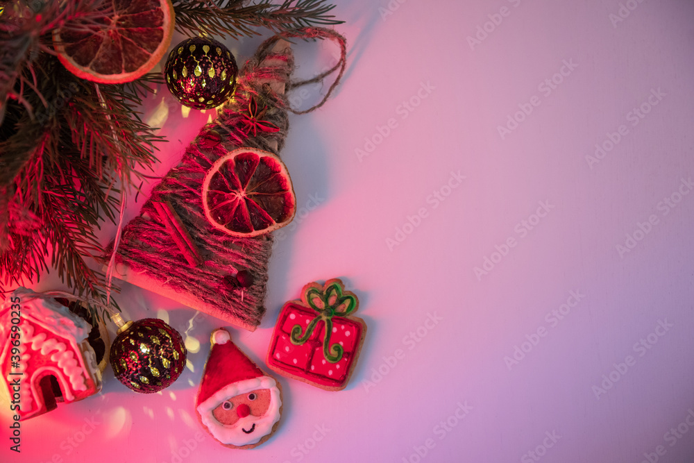 Christmas holiday neon color background with fir branches, toys garland and decorations. Xmas and Happy New Year theme. Flat lay, top view, space for text
