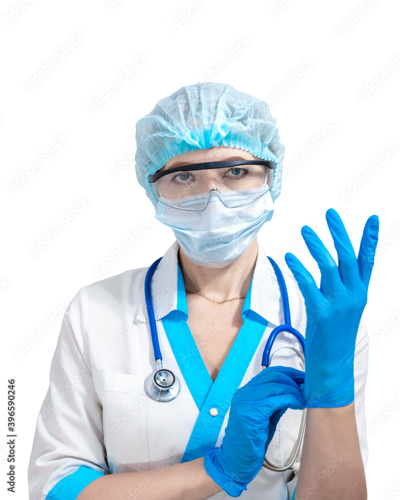 nurse in a protective mask and goggles puts on blue rubber gloves, isolated background. Medicine and health. Fighting Coronavirus. nurse in a protective mask and goggles puts on blue rubber gloves, isolated background. Medicine and health. Fighting Coronavirus.
