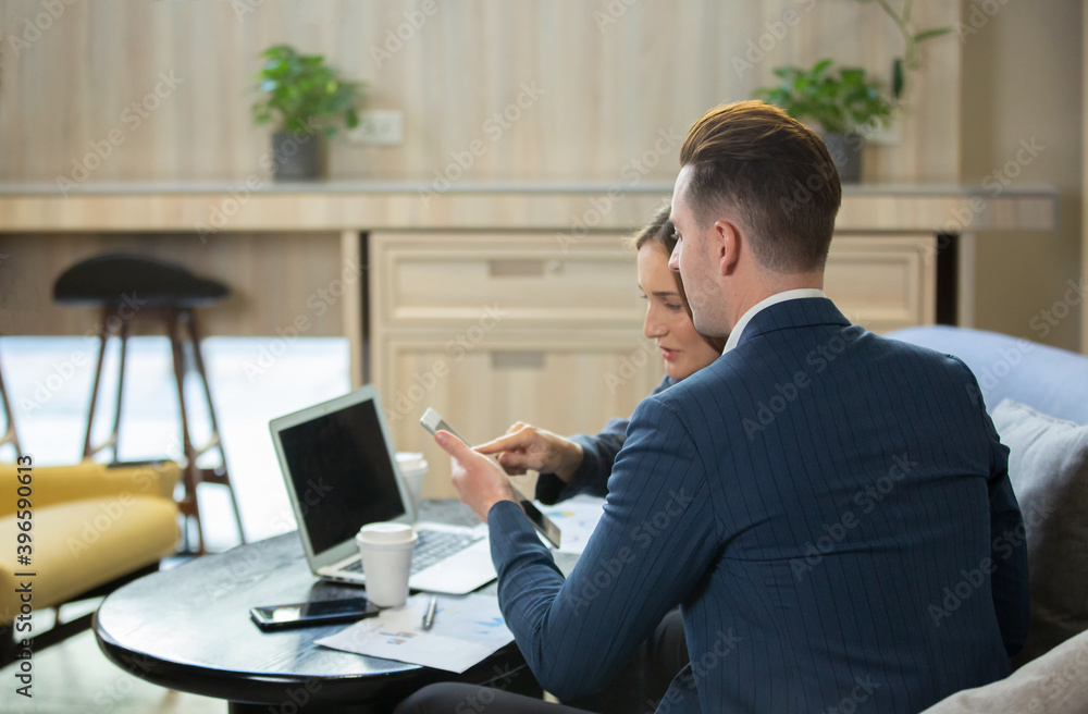 Two Cheerful Young Businessmen Using Laptop On Business Meeting Together Two Cheerful Young Businessmen Using Laptop On Business Meeting Together