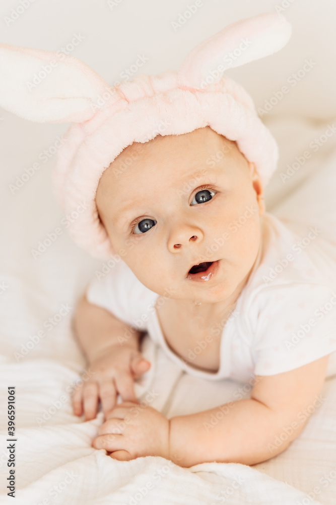 Portrait of adorable baby girl laying on comfortable bed at home, cute little kid enjoy happy childhood, beautiful toddler smiling, childcare concept Portrait of adorable baby girl laying on comfortable bed at home, cute little kid enjoy happy childhood, beautiful toddler smiling, childcare concept