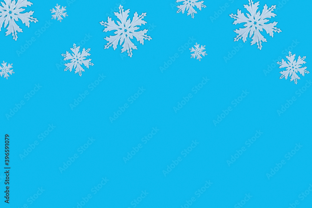Christmas pattern of white snowflakes on a blue background. Concept frame border background for Christmas and New Year with copy space Christmas pattern of white snowflakes on a blue background. Concept frame border background for Christmas and New Year with copy space
