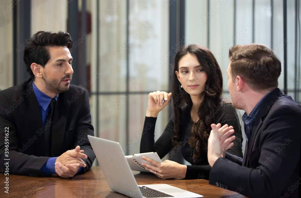 Young business team discussing and studying statistics in a meeting room Young business team discussing and studying statistics in a meeting room