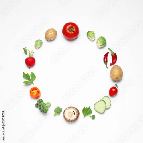 Frame of different fresh vegetables on white background, top view