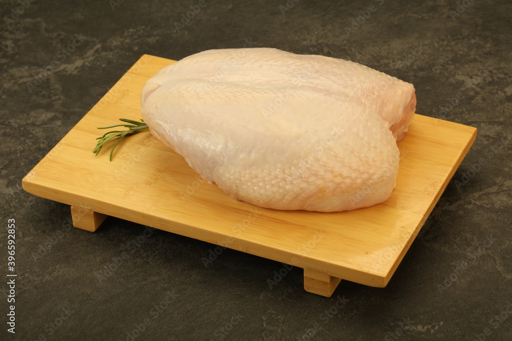 Raw whole chicken breast with skin Raw whole chicken breast with skin