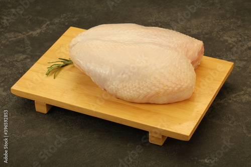 Raw whole chicken breast with skin