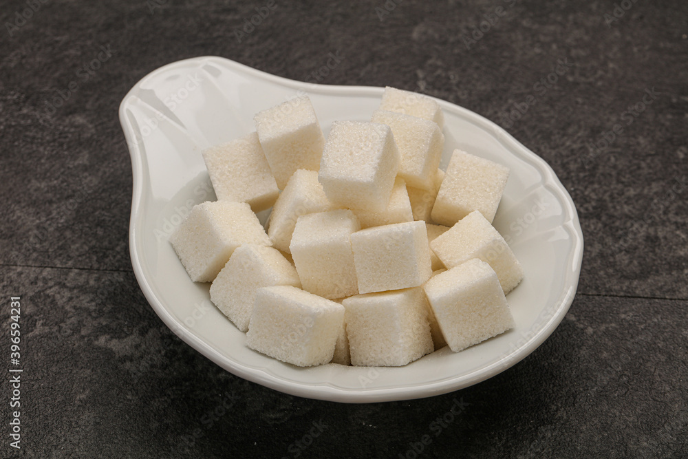 Refined white sugar cubs in the bowl Refined white sugar cubs in the bowl