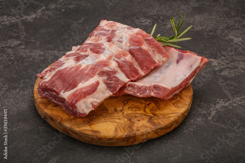 Raw pork ribs served rosemary