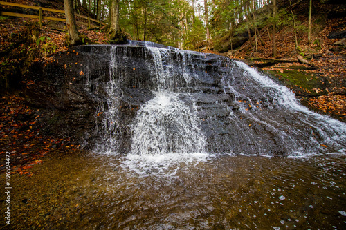 Hells Hollow Falls in McConnells Mill State Park on a cloudy November day with a dreamy waterfall.