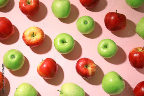 Fototapeta Naklejka Na Ścianę i Meble -  Many different ripe apples on pink background, flat lay