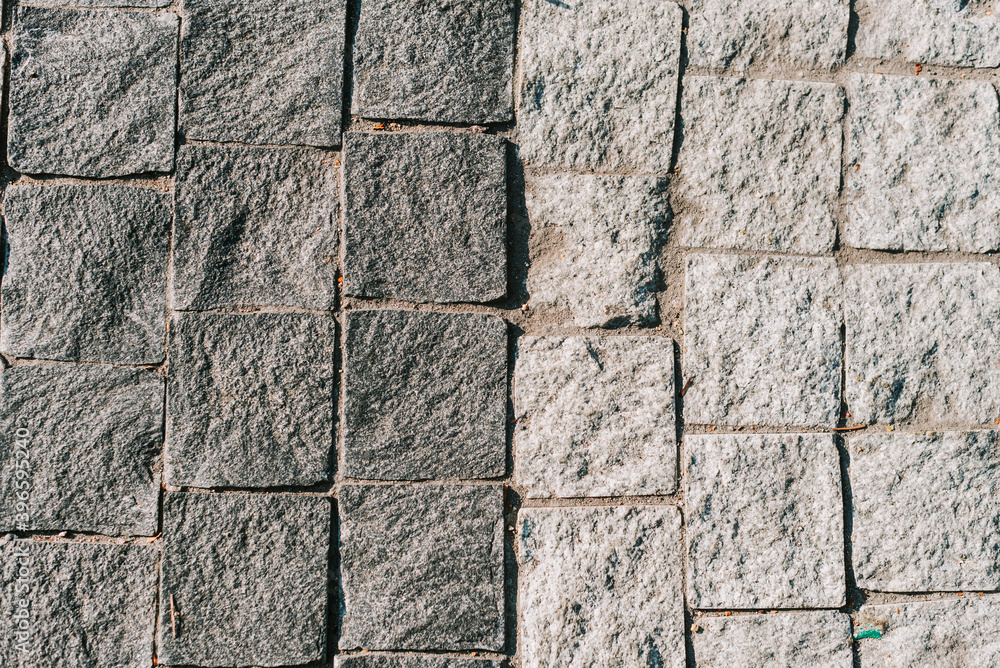 Obraz premium Texture of gray stone paving stones in close-up
