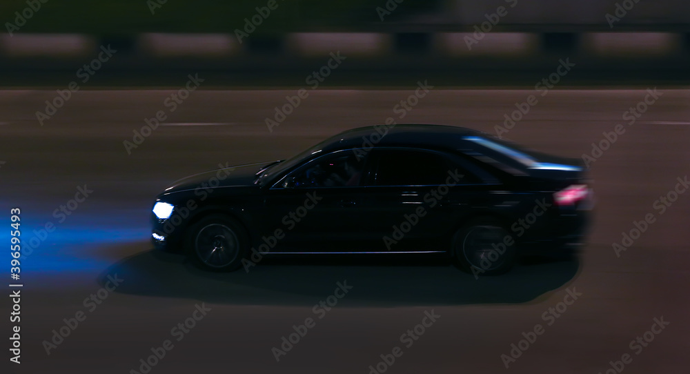 Fototapeta premium Car Drives Down the Night Street.