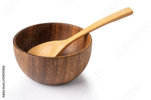 Brown wooden bowl with spoon isolate on white background with clipping path.