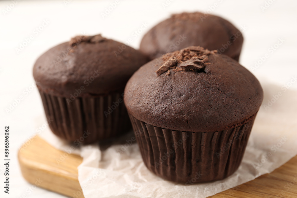Delicious cupcakes with chocolate crumbles on wooden board, closeup