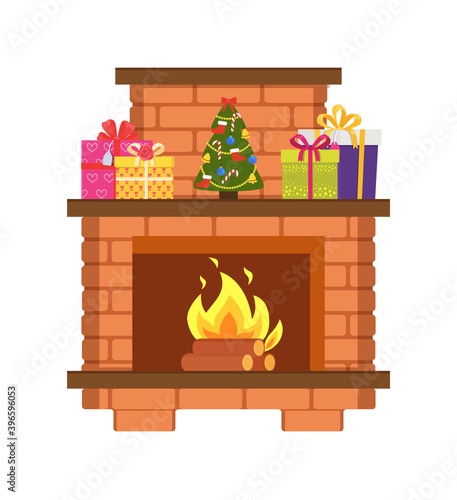 Fireplace made of fireproof bricks, with chimney, decorated by Xmas tree and gift boxes. Flames in home bonfire and New Year decorations isolated