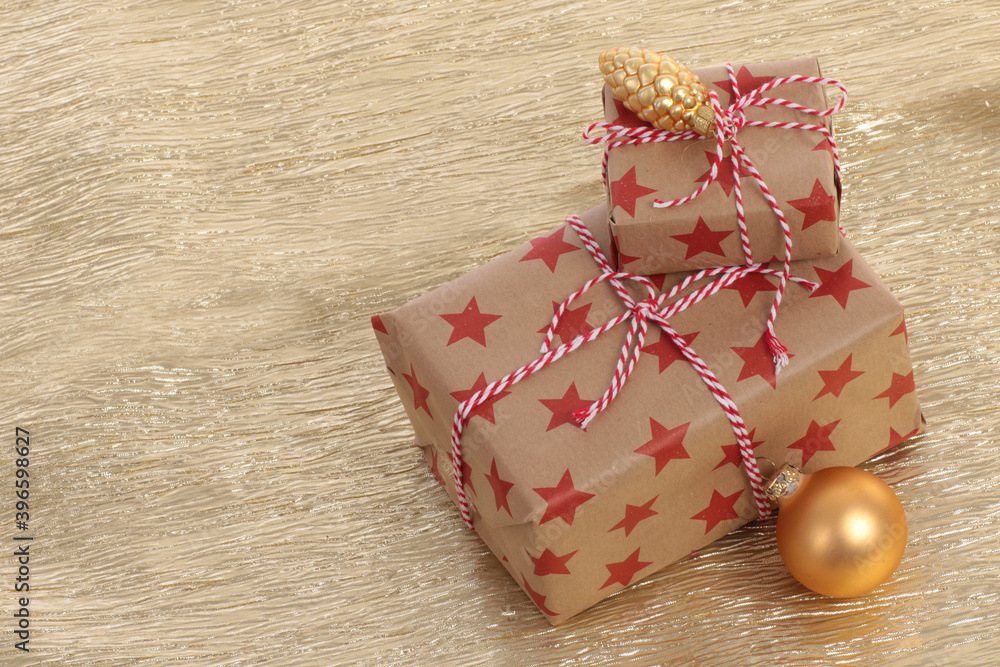Small christmas gift on a golden background Small christmas gift on a golden background