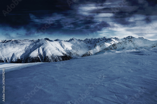 Billede på lærred Winter mountains at night surrounded by black clouds.