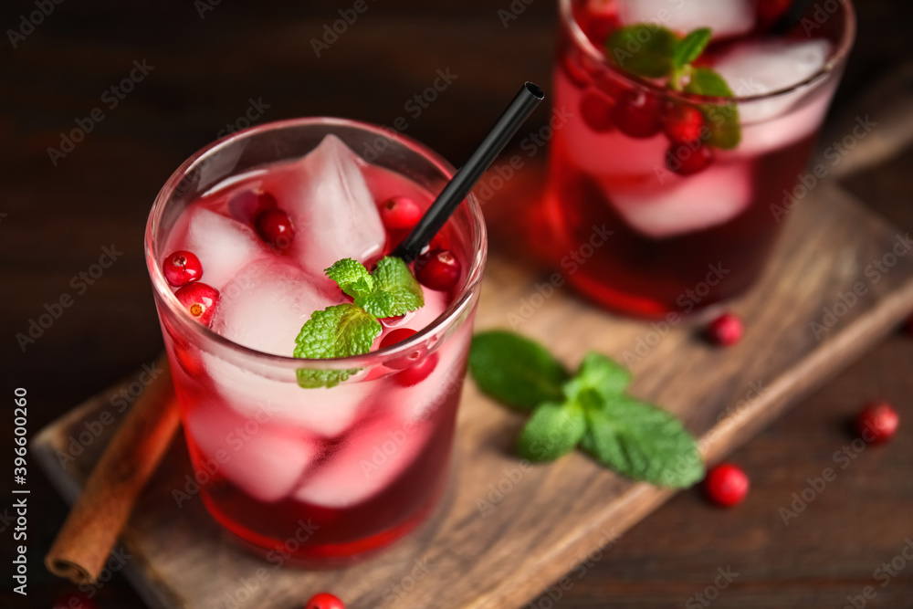 Tasty refreshing cranberry cocktail with mint on wooden table, closeup. Space for text Tasty refreshing cranberry cocktail with mint on wooden table, closeup. Space for text