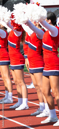 Cheerleaders cheering to the fans at a football game