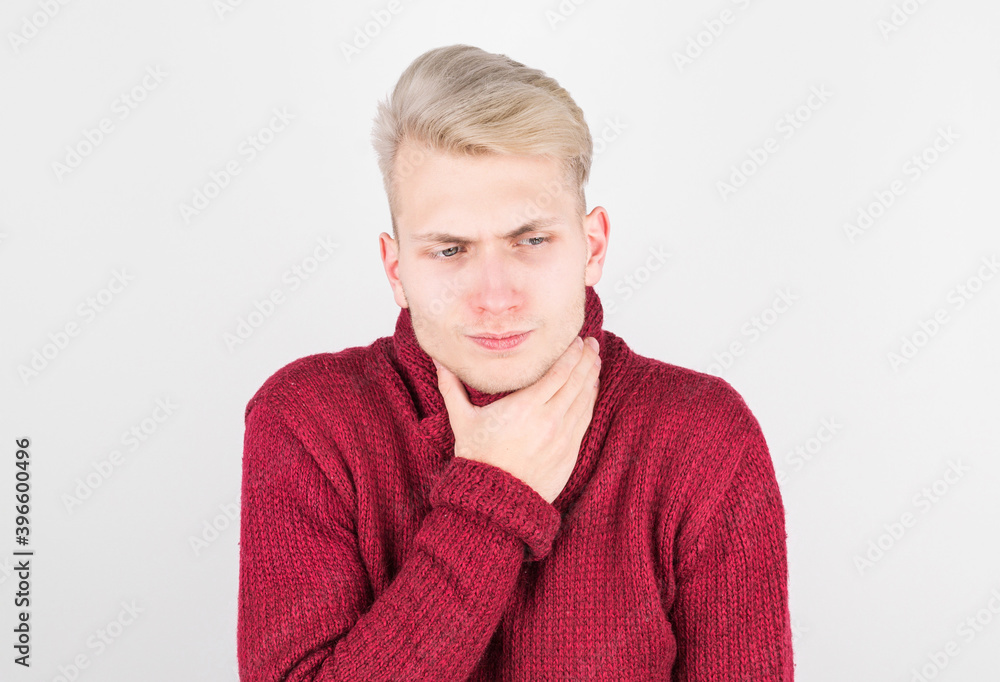 Handsome man in red scarf suffering from sore throat. The concept of medicine and seasonal colds. Handsome man in red scarf suffering from sore throat. The concept of medicine and seasonal colds.