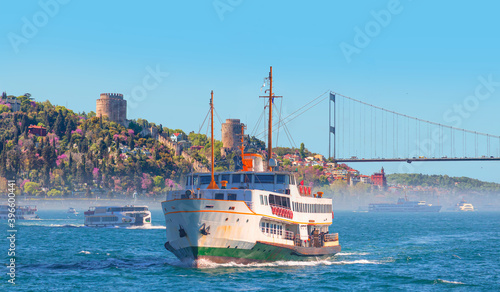 Rumeli Hisari (fortress) in to Bosphorus Sea - Water trail foaming behind a passenger ferry boat in Bosphorus, Istanbul, Turkey
