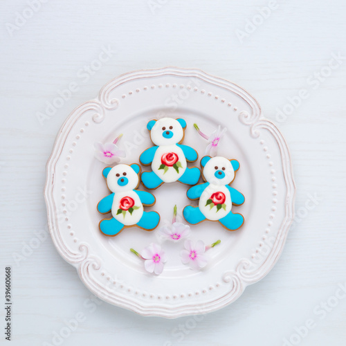 Three bear shape cookies on a plate.