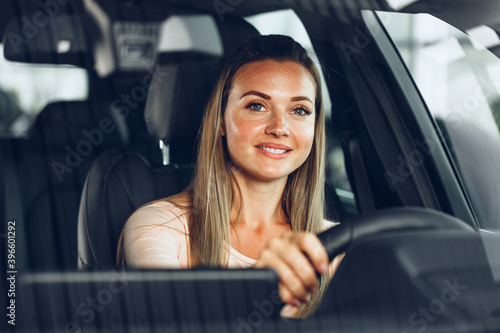Happy woman driving a car and smiling © fotofabrika