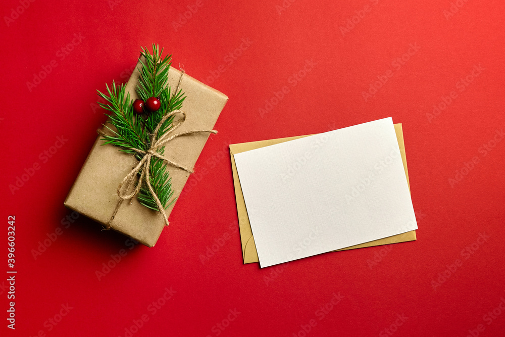 Greeting card mockup with decorated gift box on red background Greeting card mockup with decorated gift box on red background