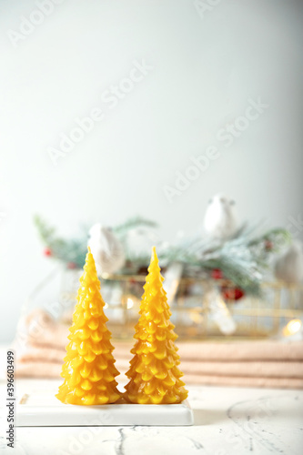 wax candles in the New Year's interior, on a light background, home comfort