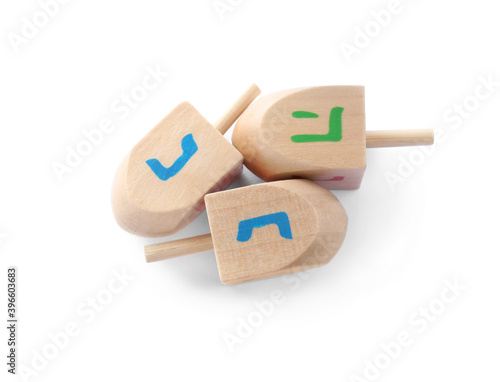 Wooden Hanukkah traditional dreidels on white background, top view photo