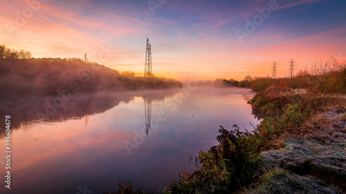 Autumn landscape with fog and frost with a river at sunrise