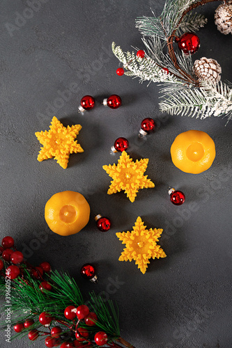wax candles in the New Year's interior, with red small balls on a dark background