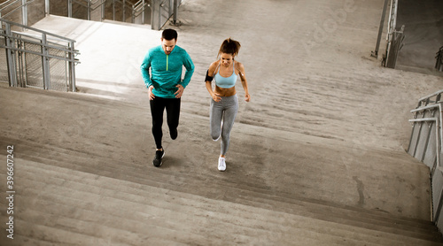 Young couple running in the...
