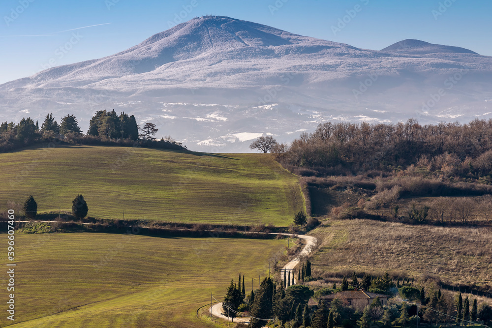 Fototapeta premium Beautiful panoramic view of Monte Amiata covered with snow from Monticchiello, Siena, Tuscany, Italy