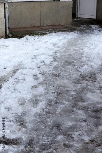 Uncleaned from snow, icy sidewalk. © Radila