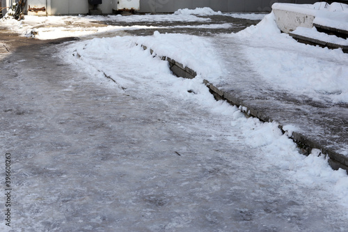Uncleaned from snow, icy sidewalk.