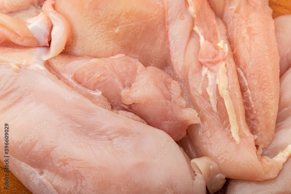 Raw chicken fillet on a wooden background. Raw chicken fillet on a wooden background.