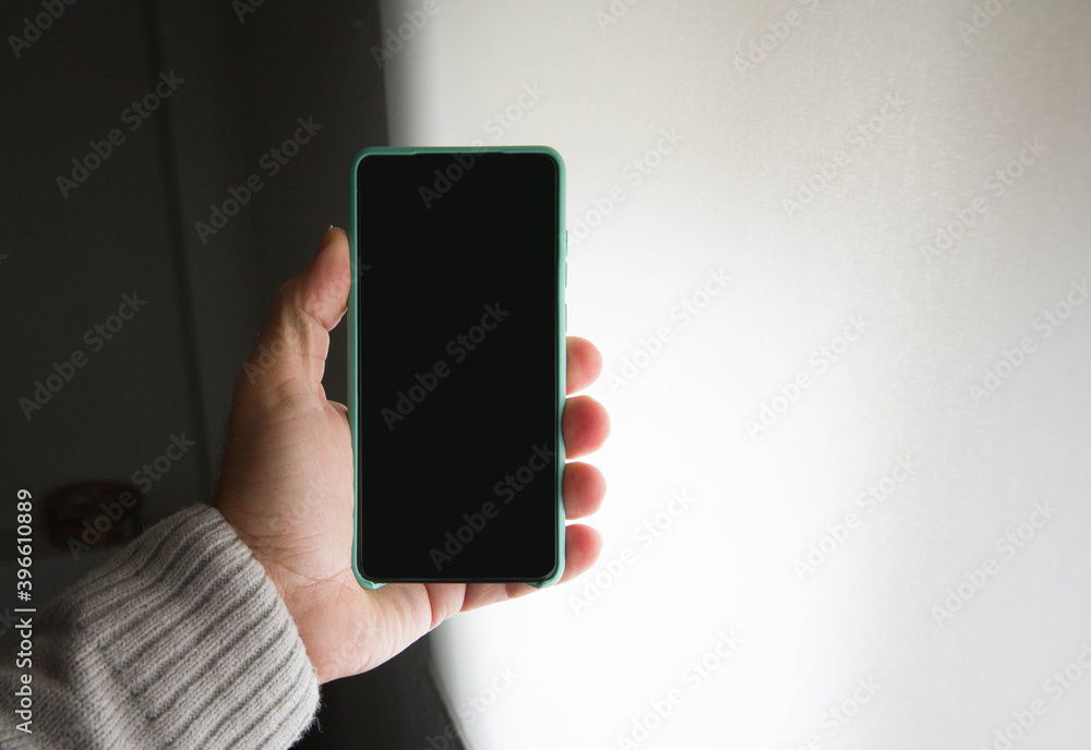 Isolated. copy space. A man holds a smartphone with one hand