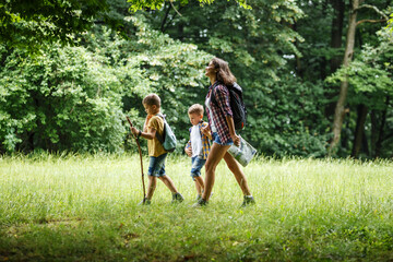  A mother and her two little sons embark on an adventurous hike through the serene forest, where they explore nature's wonders and create cherished family memories.	