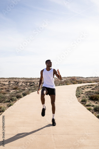 Vertical shooting of a sports trainer performing warm-ups before training. Concept of health.