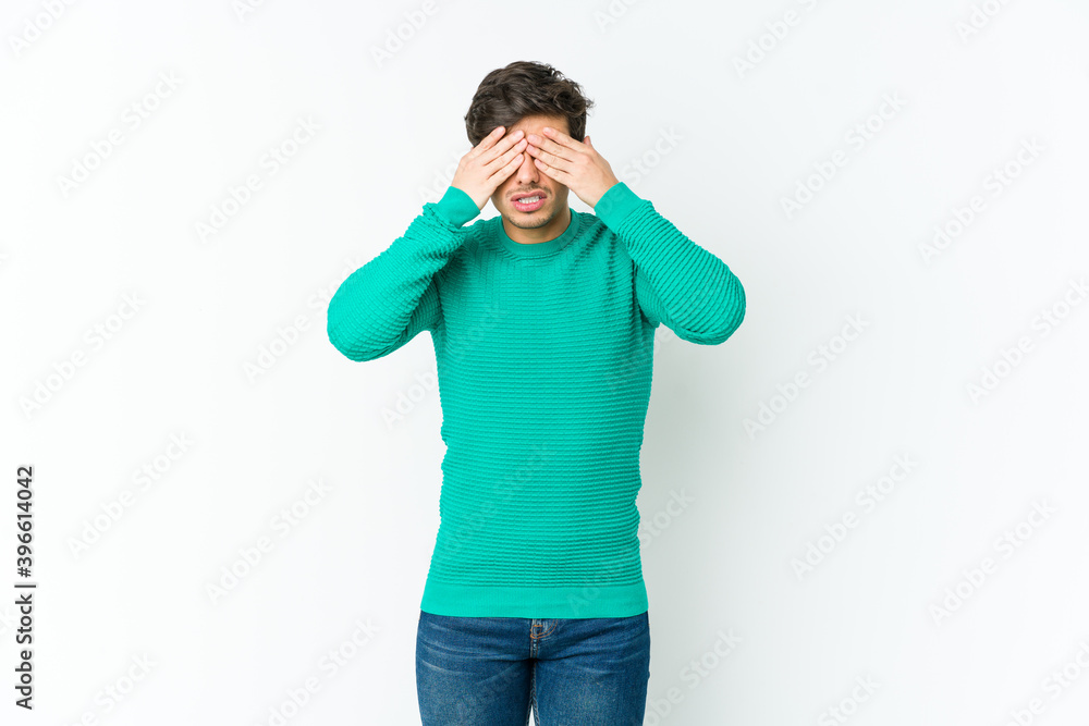 Young cool man afraid covering eyes with hands. Young cool man afraid covering eyes with hands.