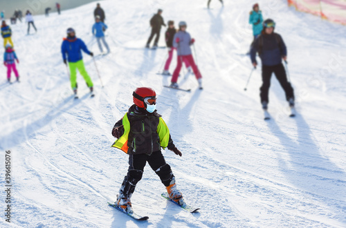 Coronavirus in winter. Skiing with face mask. winter vacation in pandemia. Portrait of caucasian young man with face mask. Winter is coming in new reality.