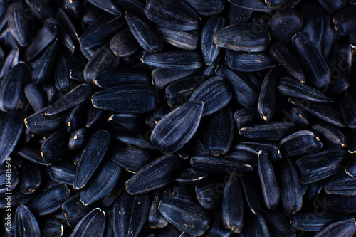 Fried black sunflowers seeds, close up.