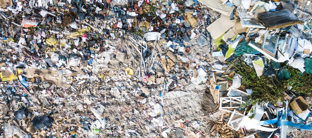 Aerial view of  dumping site of big city with different types of waste. Wooden and plastic garbage. Environmental disaster.