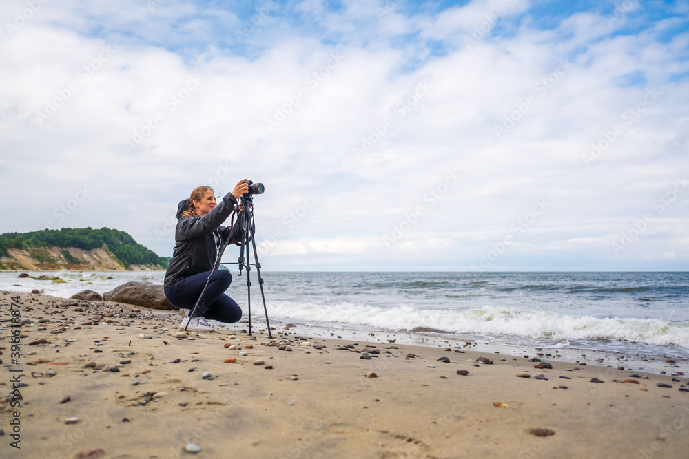 Female photographer shooting waving sea
