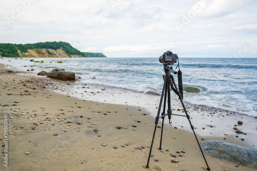 Photo camera on seashore on stormy day