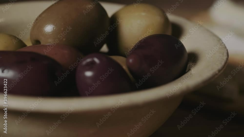 Olives and delicious French mold cheeses and red wine in close-up Olives and delicious French mold cheeses and red wine in close-up