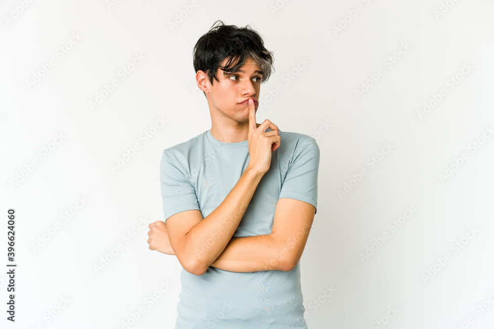Young skinny hispanic man looking sideways with doubtful and skeptical expression. Young skinny hispanic man looking sideways with doubtful and skeptical expression.